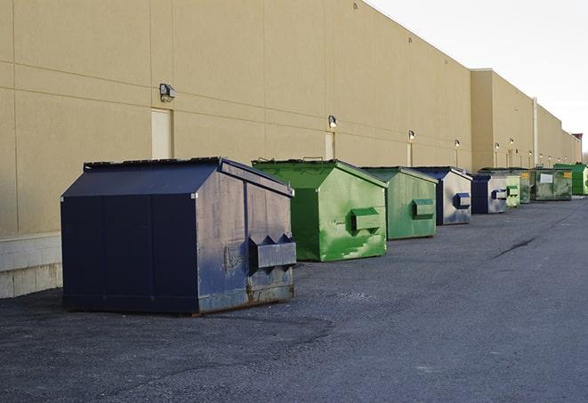 multiple construction dumpsters at a worksite holding various types of debris in Cooper City